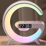 White G shaped LED lamp on wooden bedside table